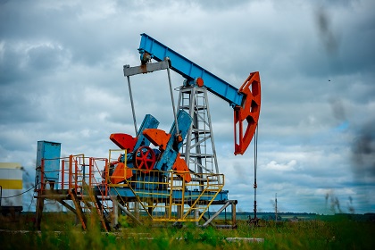 Oil,Field,With,Pump,Jack,,Profiled,On,Blue,Sky,With